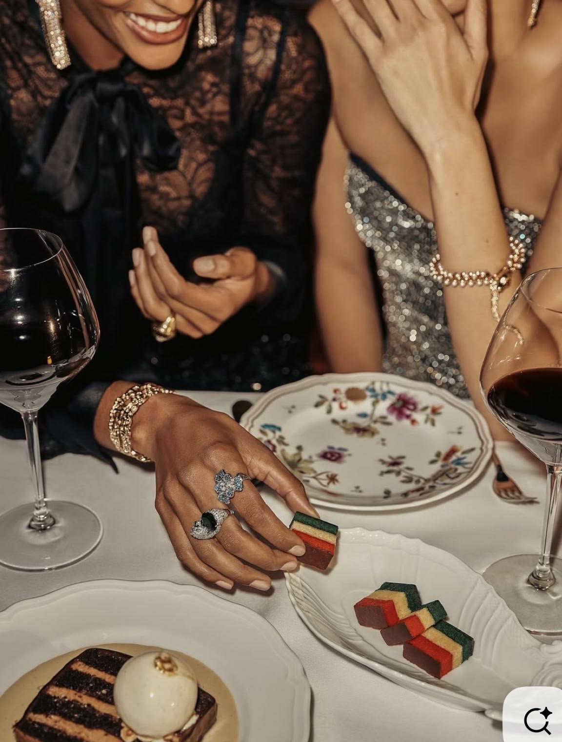 Close-up of elegant desserts and wine at a refined dinner gathering
