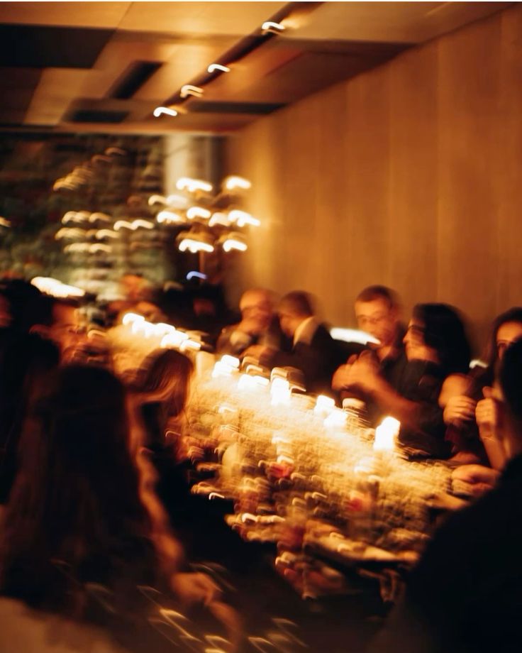 Long communal table glowing with candlelight at a private dinner