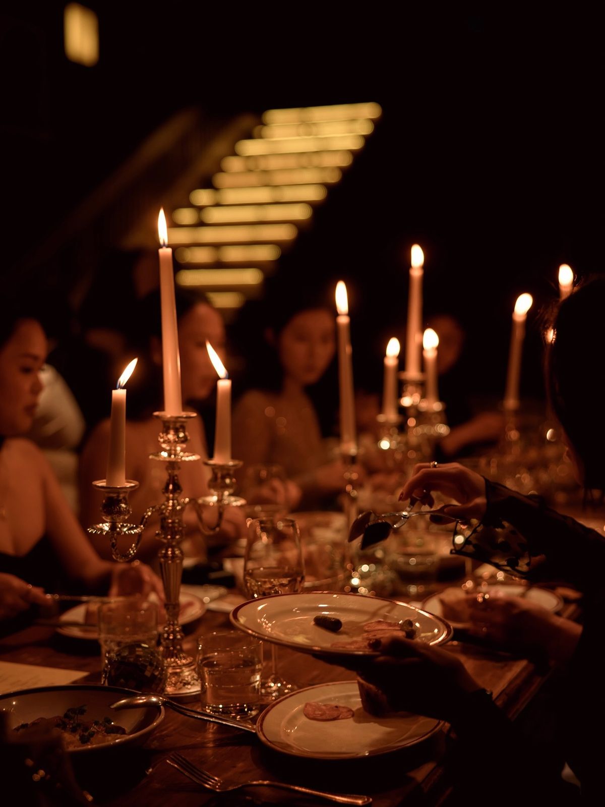 Candlelit dinner with guests around an elegant table